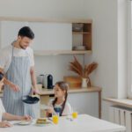 father preparing breakfast for wife and daughter