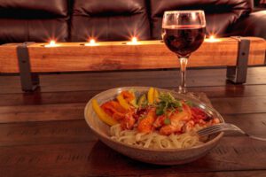 Red wine with Maine lobster over a bed of linguini with micro gr