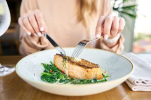 woman eating plate of seafood