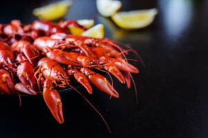 fresh hot red crawfish with lemon on dark wood table