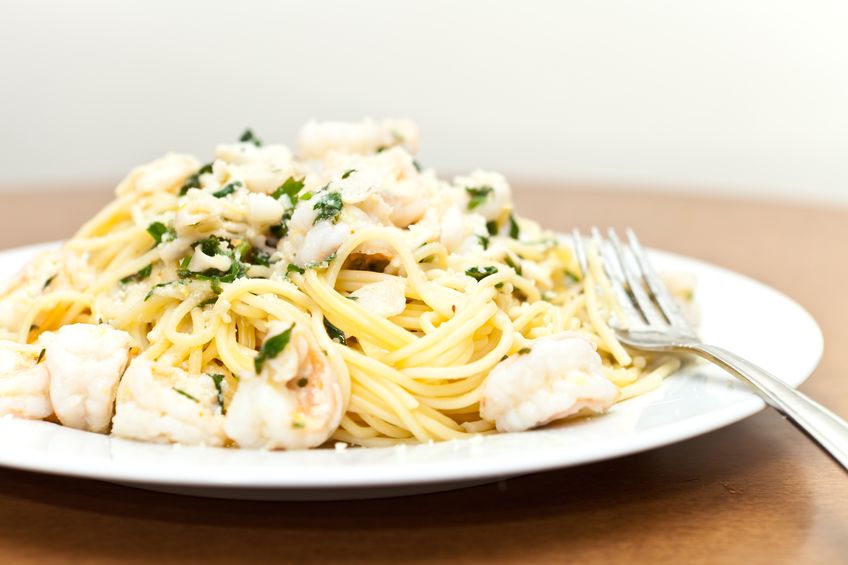 a delicious shrimp scampi pasta dish with calamari parsley garlic and olive oil.
